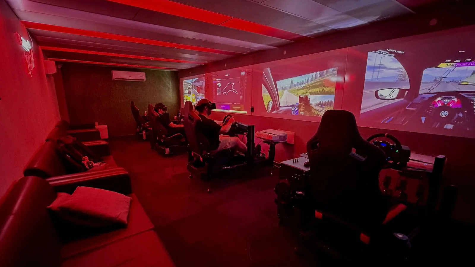 Two racers head to head on side by side sim racing rigs