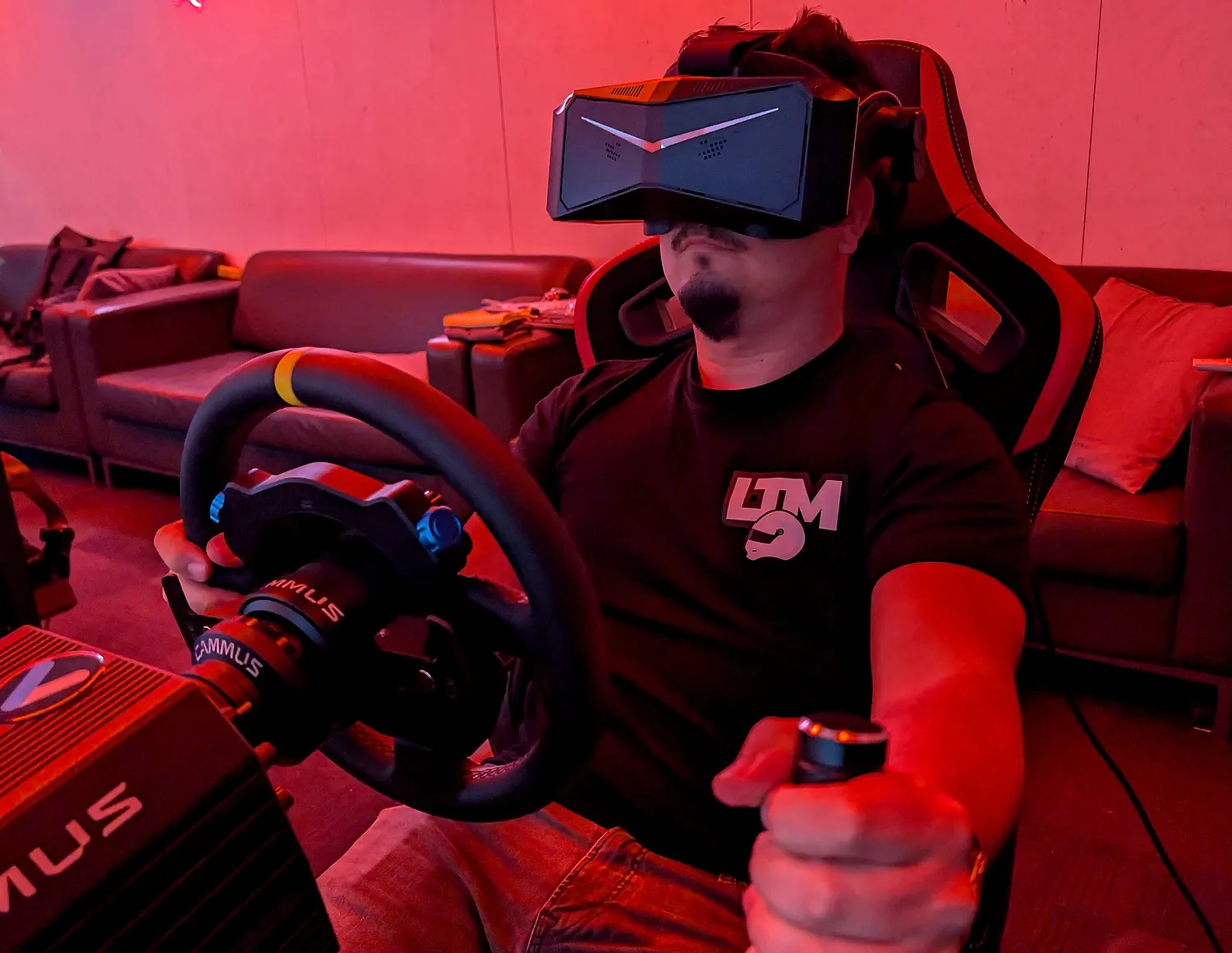 Racer in a VR headset gripping a direct drive wheel at Sim Racing Adelaide